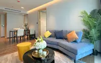 2 Bedroom Condo for Sale at Beverly Mountain Bay Pattaya stylish living room with blue L-shaped sofa and indoor palm plant
