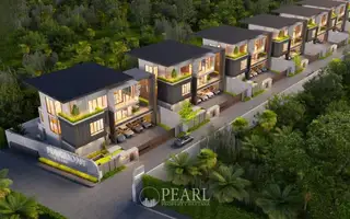 Harmony Hills Villas Pattaya: Aerial view of multiple modern villas nestled in lush green landscape with a road.