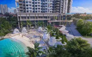 Copacabana Coral Reef infinity pool on a high floor, overlooking a city skyline under a blue sky.
