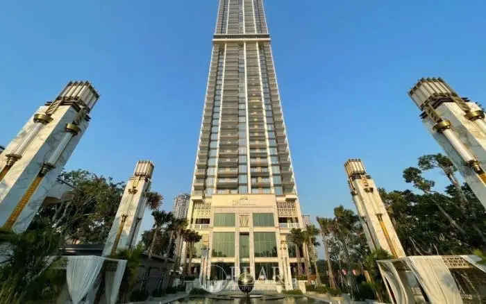 Copacabana Beach Jomtien: Grand exterior view of the tall, modern condo building with decorative pillars and water feature.