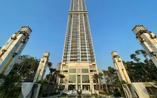 Copacabana Beach Jomtien: Grand exterior view of the tall, modern condo building with decorative pillars and water feature.