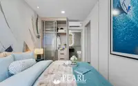 3 Bedroom Condo for Sale at Aquarous Jomtien Pattaya: Bedroom with built-in wardrobe, bed, and ensuite bathroom entrance.