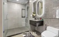 3 Bedroom Condo for Sale at Aquarous Jomtien Pattaya: Contemporary bathroom with glass shower, floating vanity, and illuminated mirror.