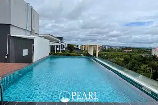 Neo Sea View rooftop swimming pool with turquoise tiles, surrounding deck, and city views under a cloudy sky.