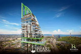 Riviera California modern high-rise condo building with green accents, balconies, and a pool, overlooking Pattaya city and ocean.