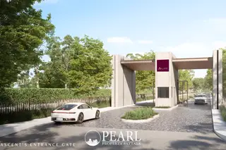 Baan Pattaya 7 (Ascent) modern entrance gate with a white sports car, lush green landscaping, and security booth.
