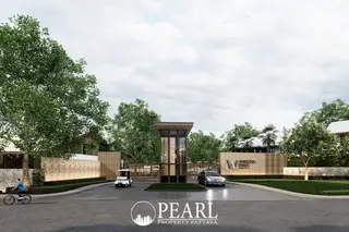 Wisdom First Residences main entrance gate with signage, security booth, and lush green trees.