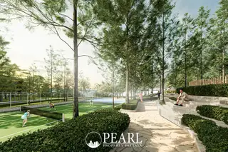 Wisdom First Residences tennis courts and outdoor amphitheater seating surrounded by tall trees.