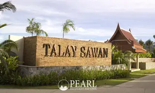 Talay Sawan Bang Saray entrance sign on a brick and stone wall with palm trees and a traditional Thai pavilion.