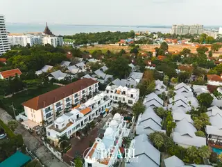Wongamat Exclusive Place aerial view of multiple white townhouses with domed roofs and surrounding neighborhood.