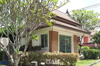 T.W. Wanasin modern white villa with a private swimming pool, green lawn, and multiple balconies.