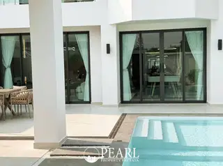 View Point Village outdoor patio with dining set next to a private swimming pool.