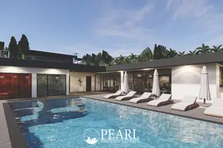 Siam Royal View Lakeside large outdoor swimming pool with lounge chairs, umbrellas, and modern architecture.