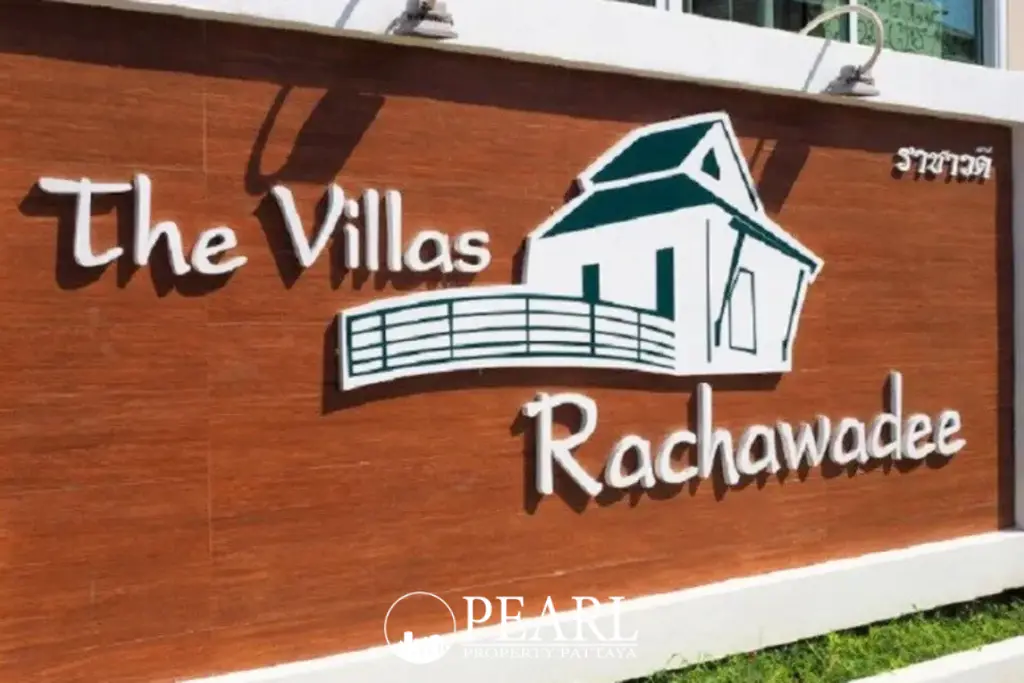 The Villa Rachawadee entrance sign featuring the property name and a house silhouette logo.