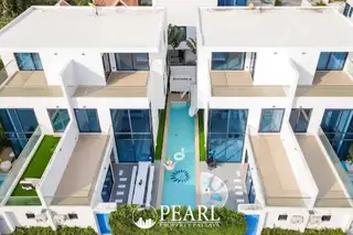 Palm Spring villa Pattaya aerial view of two modern white villas with a long narrow swimming pool and inflatables.
