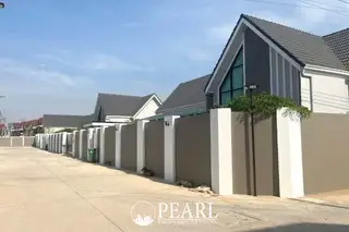 Parkside Pool Villas street view with modern houses featuring grey roofs and white and grey walls.