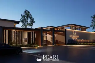 Baan Mae 12 – Onyx Grand Village exterior entrance at dusk with illuminated signage and a car.