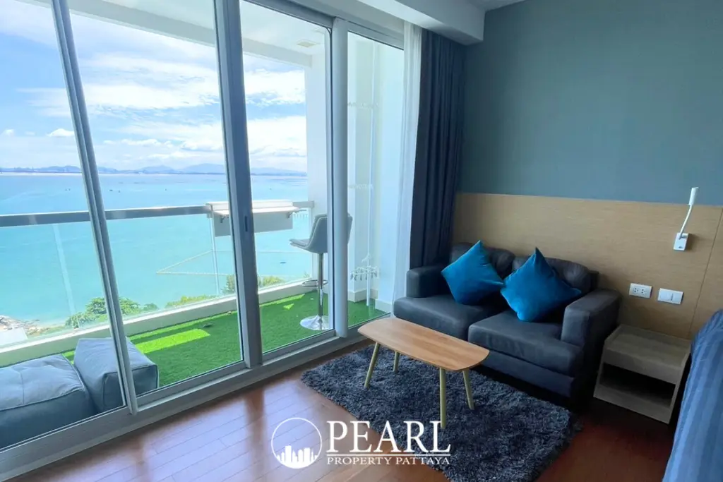 1 Bedroom Condo for Sale at Palm Wongamat living room with sofa and TV