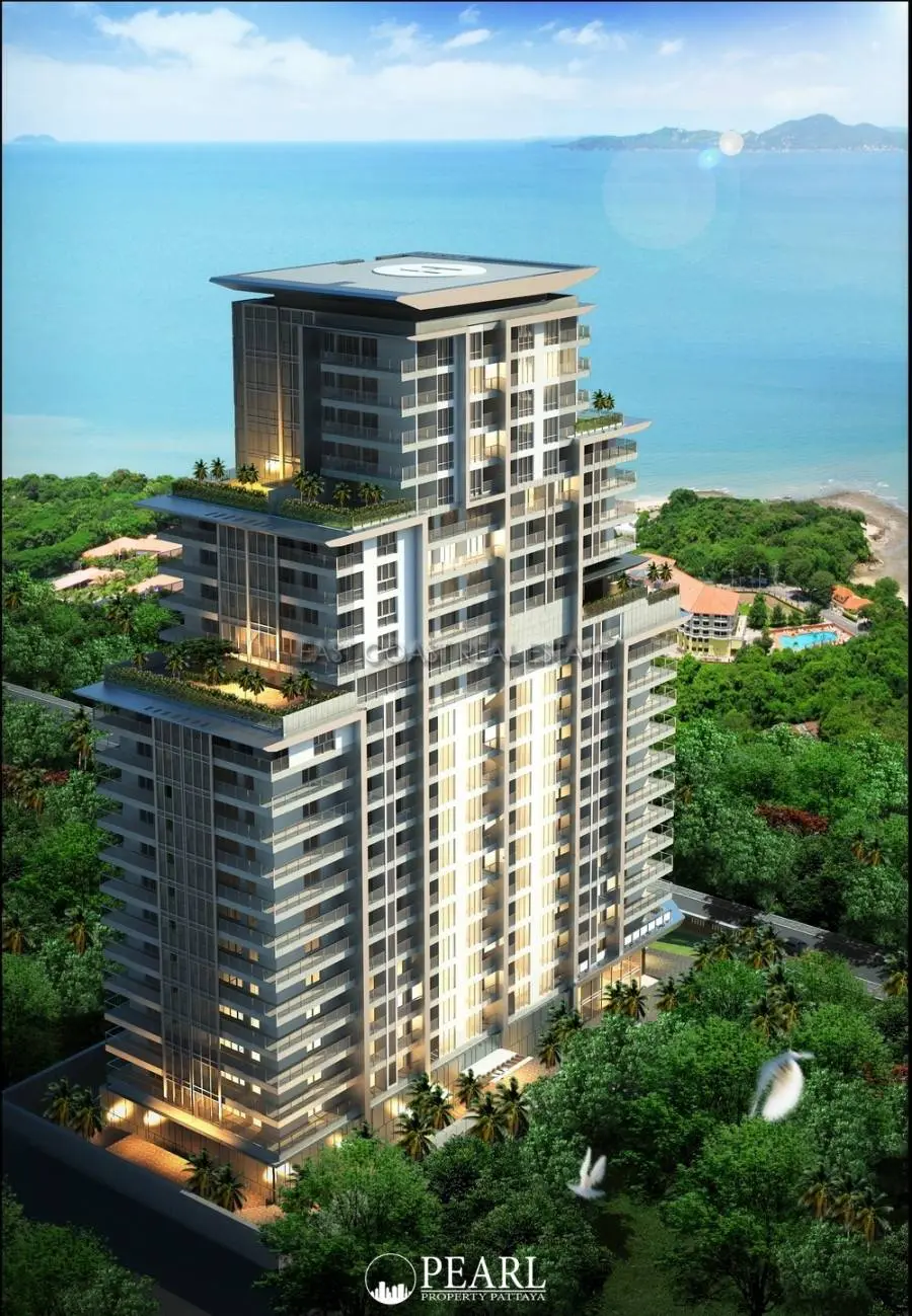 Cosy Beach View modern condominium building exterior with balconies, lush green trees, and ocean in the background