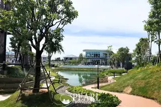 Patta Element outdoor swimming pool with decorative floats, overlooking a lake and modern houses.