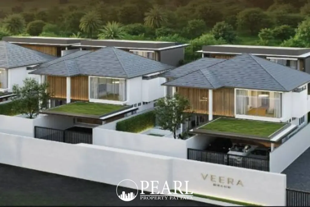 Veera Grand modern houses with gray roofs, white facades, wooden accents, and green carports, surrounded by lush trees.