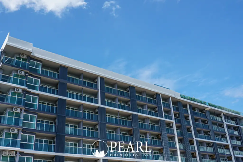 Sea Saran modern condominium building exterior with multiple balconies and a clear blue sky.
