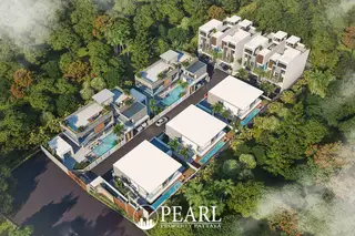 Tree Villa aerial view of multiple modern villas with private pools surrounded by dense green trees.