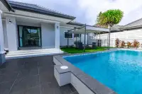 3 Bedroom House for Sale at Phonthep Garden Ville 2 bright living room with beige sofa gold chandelier and marble feature wall