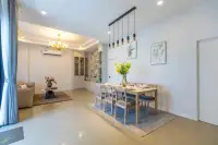 3 Bedroom House for Sale at Phonthep Garden Ville 2 open-plan dining and living area with wood dining table and gold chandelier