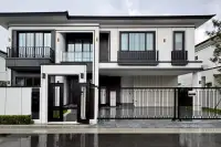 4 Bedroom House for Sale at Chieftain modern two-storey exterior with black iron gate, balconies, and white facade