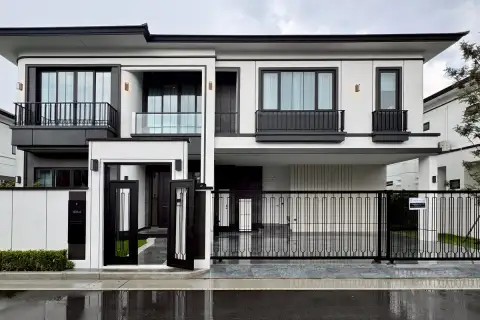4 Bedroom House for Sale at Chieftain modern two-storey exterior with black iron gate, balconies, and white facade