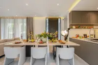 4 Bedroom House for Sale at Cascade dining table with marble top and grey chairs adjacent to modern kitchen