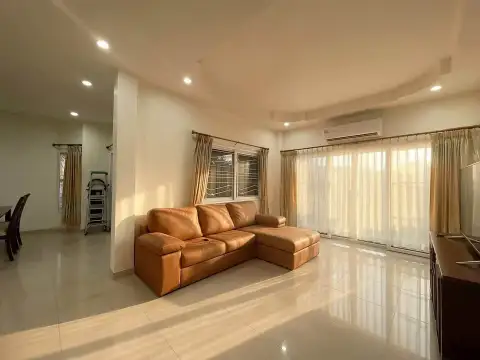 3 Bedroom House for Rent at PMC Home 4 open-plan living area with sectional sofa, tiled flooring and bright windows