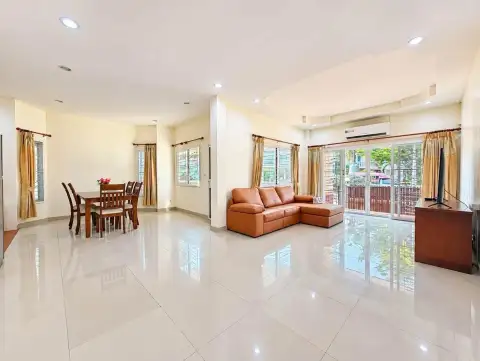 3 Bedroom House for Rent at PMC Home 4 open-plan living and dining area with leather sofa and glossy tile floors