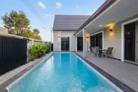 3 Bedroom House for Sale in Pong featuring long lap pool alongside covered terrace at dusk