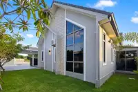 3 Bedroom House for Sale in Pong showing modern exterior with floor-to-ceiling windows and lawn