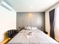 3 Bedroom House for Sale in Mabprachan master bedroom with gray upholstered headboard and accent chair