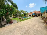 3 Bedroom House for Rent in Pong wide driveway leading to pool area and flowering garden shrubs