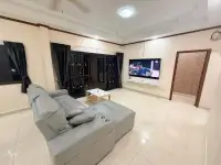 3 Bedroom House for Rent in Pong open living area with sectional sofa and wall-mounted television