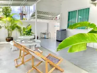 3 Bedroom House for Rent in Mabprachan covered patio with stone table, lounge chairs and sink area