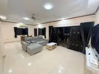 3 Bedroom House for Rent in Pong spacious living room with gray sofa and dining area at night