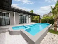 4 Bedroom House for Rent in Mabprachan L-shaped swimming pool with poolside patio and garden