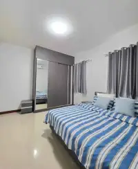 4 Bedroom House for Rent in Mabprachan bedroom with striped blue bedding and mirrored wardrobe