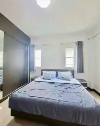 4 Bedroom House for Rent in Mabprachan bedroom with gray bedding and twin curtained windows