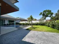 5 Bedroom House for Rent in Mabprachan poolside patio and green lawn beside covered terrace