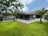 5 Bedroom House for Rent in Mabprachan rear view of villa with L-shaped pool and landscaped garden