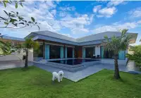 5 Bedroom House for Rent in Mabprachan backyard pool and lawn with small white dog under blue sky
