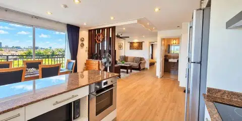 1 Bedroom Condo for Rent at Porch Land 2 open kitchen with granite counters overlooking dining and living area