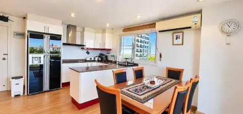1 Bedroom Condo for Rent at Porch Land 2 dining area with wooden table and open kitchen with city view