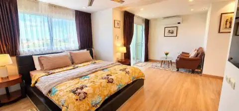 1 Bedroom Condo for Rent at Porch Land 2 bedroom with king bed, seating area, and balcony access